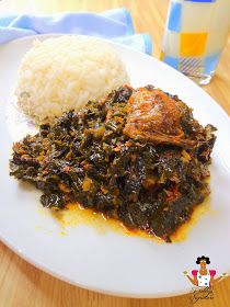 a white plate topped with rice and meat next to a glass of milk on a wooden table