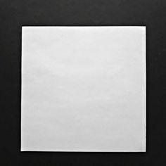 a square white piece of paper sitting on top of a table