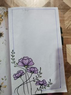 a piece of paper with flowers drawn on it next to another piece of art work