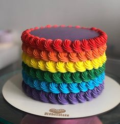 there is a rainbow cake on the plate