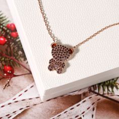 This brown bear necklace makes an adorable gift for yourself or loved ones. Beautifully handcrafted in sterling silver, it features a cute bear with brown and pink stone accents, while the pink round cut stone is decorated in a heart shape on the bear's body. Stunning and sparkling, this bear-inspired necklace will capture your heart at first sight. You can`t feed a real bear but you can have this necklace.Carat Weight: 1.545 ctStone Size: 1,1.2,2.2 mmStone Type: Jeulia® StoneNumber of Stones: 6 Brown And Pink, Bear Necklace, Inspired Necklace, Pink Round, Bear Design, Cute Bear, Pink Stone, Cute Bears, Brown Bear