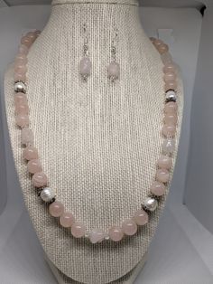 "This set is very pretty. It is made of 10mm rose quartz round beads, 6x10 mm dog bone rose quartz beads, 4mm bicone clear crystals and approx. 8 x 10 genuine white cultured pearls. The necklace measures 22\" (inches) end to end. It is finished with a silver plated toggle clasp.  The earrings are made of the rose quartz dog bone bead with 4mm crystals. It hangs 1. 1/16 of an inch just below the ball of the silver plated French wire  The rose quartz is a very pretty pale pink which I was having trouble trying to get with my camera. I ship USPS so that your package will arrive safe and sound in only a few days!  Satisfaction is always guaranteed!  You can email me at  lynnsattic@gmail.com or convo me with any suggestions, questions, ideas or comments.  I'm always very happy to hear from you! White Rose Quartz Jewelry For Jewelry Making, Elegant Rose Quartz For Jewelry Making, Elegant Jewelry With 8mm Beads For Mother's Day, Elegant 8mm Beads Jewelry For Mother's Day, Elegant 8mm Beaded Jewelry For Mother's Day, Pink Pearl Jewelry With 8mm Beads, White Rose Quartz Jewelry With 8mm Beads, Pink Pearl Jewelry With Gemstone Beads, Elegant Rose Quartz Round Beaded Jewelry