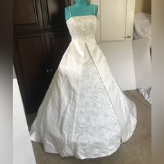 a white wedding dress on display in a room