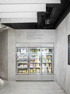 the refrigerators are stocked with food and drinks for sale at the grocery store's entrance