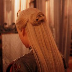 a blonde woman with long hair in a ponytail