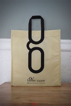 a bag with the number eight on it sitting on top of a wooden table next to a wall