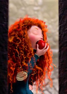 a doll with red hair holding an apple