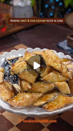 a white plate topped with fried food on top of a checkerboard tablecloth