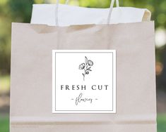 a brown paper bag with a flower on it and the words fresh cut written in black