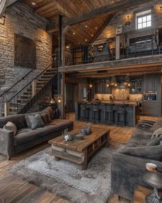 a living room filled with furniture next to a stone wall and wooden floored walls