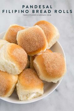 small rolls in a white bowl on a marble counter top, ready to be eaten