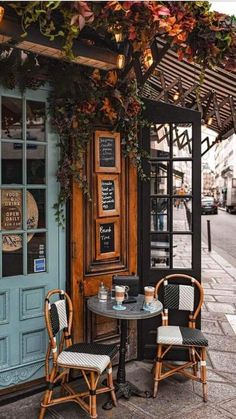 two chairs and a table in front of a building