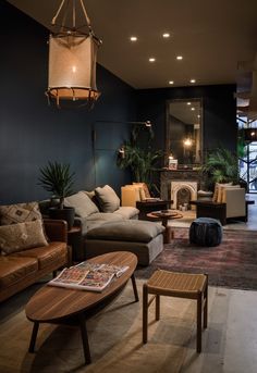 a living room filled with furniture and a fire place in the middle of it's walls