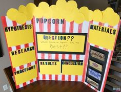 a table with some signs on it that say, pop corn questions and what is the best one?