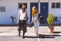 a man and woman walking down the street