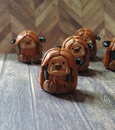 small ceramic dogs sitting on top of a wooden table