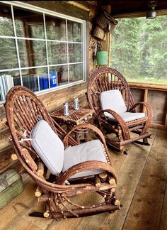 two wooden rocking chairs sitting on top of a wooden floor