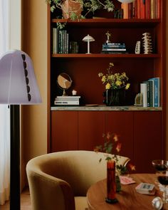 a living room filled with furniture and bookshelves