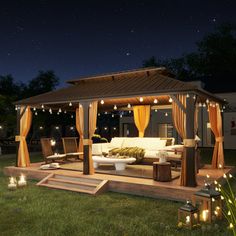 a gazebo with lights on it in the grass at night, surrounded by lawn furniture