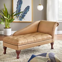 a tan leather chaise lounger sitting on top of a rug in front of a window