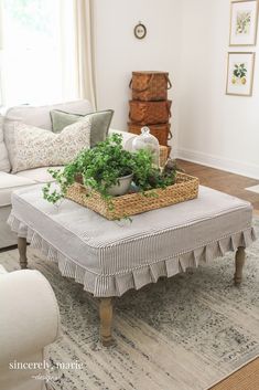 a living room filled with furniture and a basket on top of a coffee table in front of a window