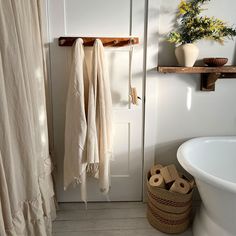 a bathroom with a towel rack, toilet and bathtub