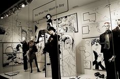 an assortment of mannequins are on display in a store window with black and white art