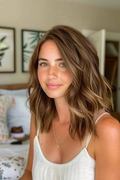 Woman with shoulder-length wavy hair smiling in a bedroom. Hair Colour Caramel Brown, Full Caramel Highlights For Dark Hair, Short Caramel Hair Honey, Warm Caramel Honey Highlights, Dark Blonde Caramel Balayage, Orange To Brown Hair, Soft Highlights Brown Hair, Medium Brown Caramel Highlights, Brown Hair With Soft Blonde Highlights