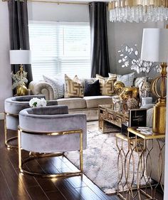 a living room filled with lots of furniture and gold accents on top of wooden floors