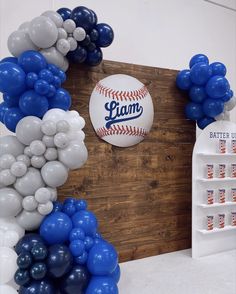 balloons and baseballs are arranged on the wall in front of a sign that says i am