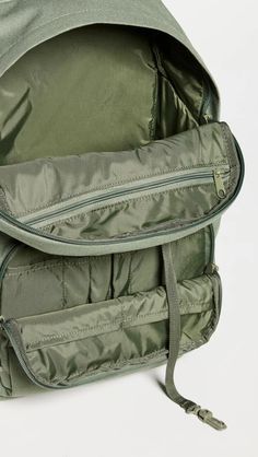 Fabric: 600D Polyester Canvas.Tonal design.Zip closure.Zip, slip, and patch interior and zip exterior pockets.Adjustable shoulder straps.Nylon lining.Weight: 21oz / 0.6kg.Imported, Vietnam Green Bags With Functional Pockets For Travel, Green Bags With Functional Pockets For Trips, Outdoor Nylon Bag With Zipper Closure, Green Nylon Backpack With Pockets, Green Nylon Backpack With Zipper Pocket, Nylon Hiking Bag With Zipper Closure, Nylon Softback Bag For Outdoor Activities, Functional Green Backpack With Zipper Closure, Green Backpack With Zipper For Trip