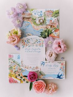 the wedding stationery is laid out on top of each other, including flowers and cards