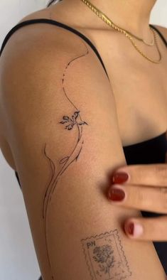 a woman's arm with a small tattoo on the left side of her arm