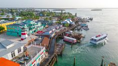 an aerial view of a harbor with boats and colorful houses on the water in the background