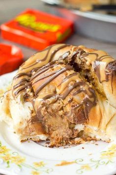 a close up of a pastry on a plate with chocolate drizzled on it