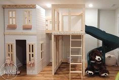 a child's loft bed with a slide and ladder to the top bunk, next to a teddy bear