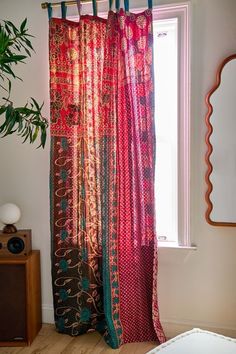 the curtains in this room are colorful and have an interesting pattern on them as well