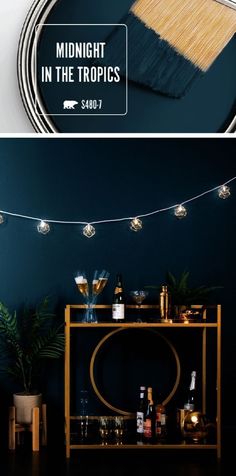 the midnight in the tropics poster is displayed on a dark blue wall with string lights