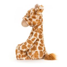 a giraffe stuffed animal sitting on the ground