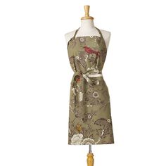 an apron on a mannequin with a bird and flower pattern in the front