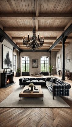 an elegant living room with wood floors and exposed ceilings, black leather couches, chandelier