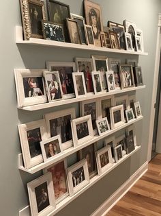 a wall filled with pictures and framed photos