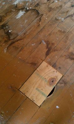 a wooden floor with a hole in it