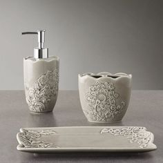 a bathroom set with soap dispenser, soap dish and toothbrush holder