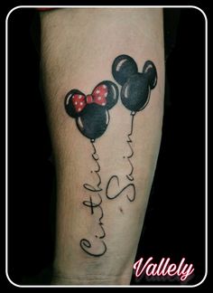 mickey and minnie mouse tattoo on the leg with name written in black ink that says,'hello kitty '