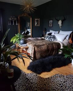 a bed room with a neatly made bed and lots of plants