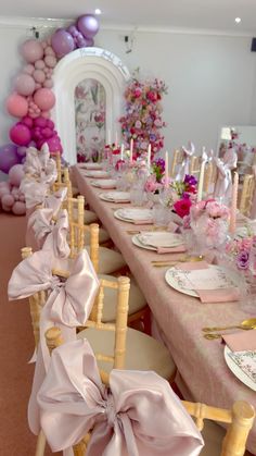 a long table with pink and purple decorations