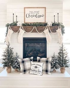 a fireplace mantel decorated for christmas with stockings and trees