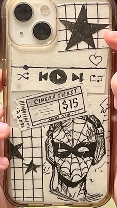 someone is holding up their phone case with some drawings on it