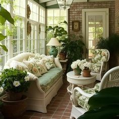 the sun room is filled with potted plants